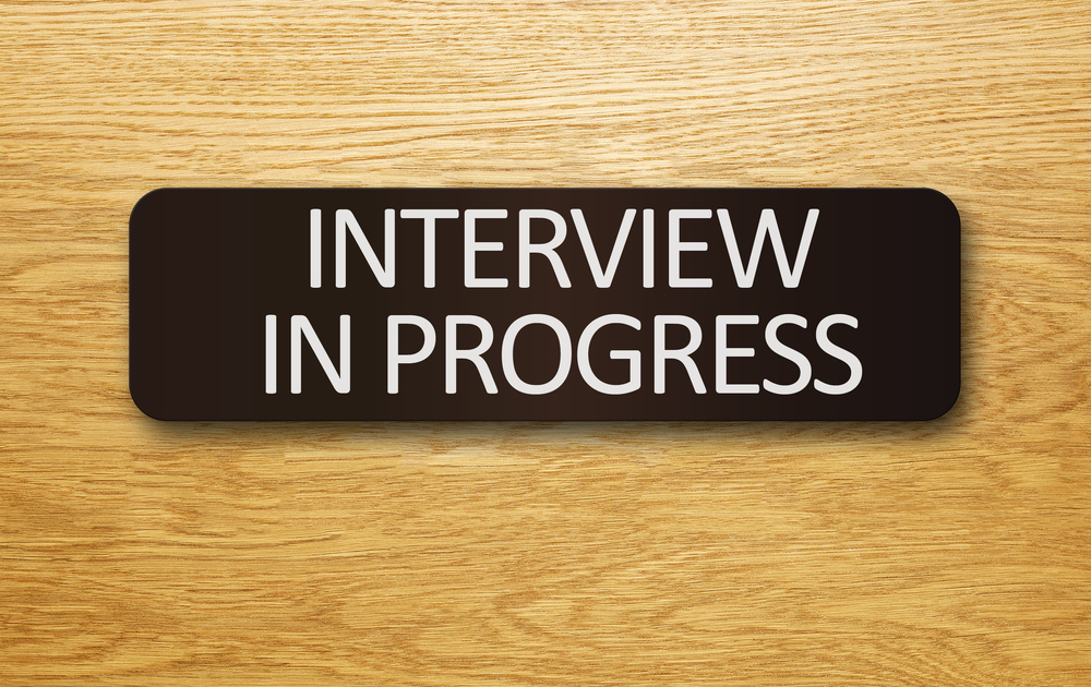 "Interview In Progress" sign on an office door.
