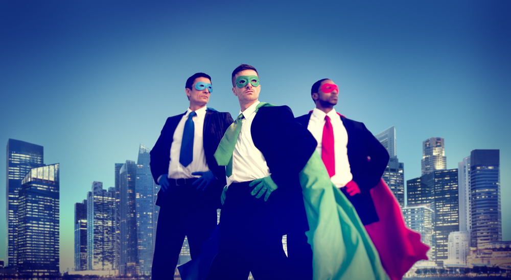 Three business leaders in superhero costumes in front of New York skyline