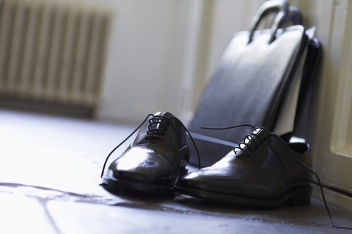 Dress Shoes and briefcase on floor close up.