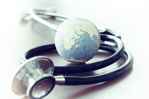 Image of stethoscope wrapped around the world - worldwide health concept