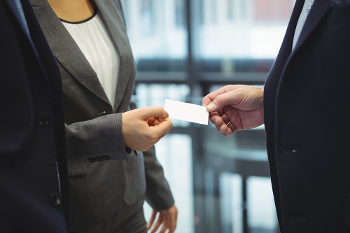 Business executives giving business cards to each other